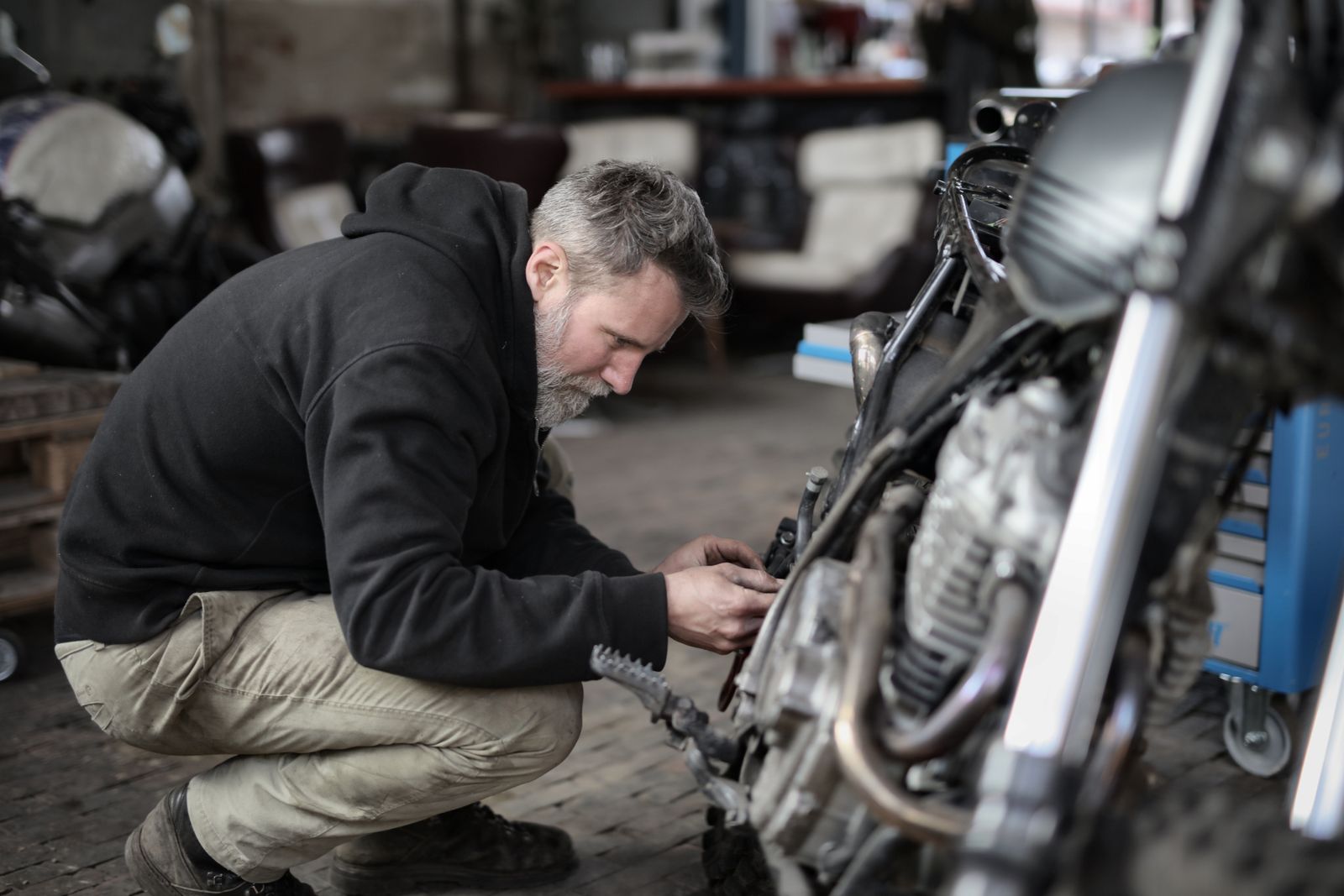 Mechanic servicing a motorcycle in a workshop