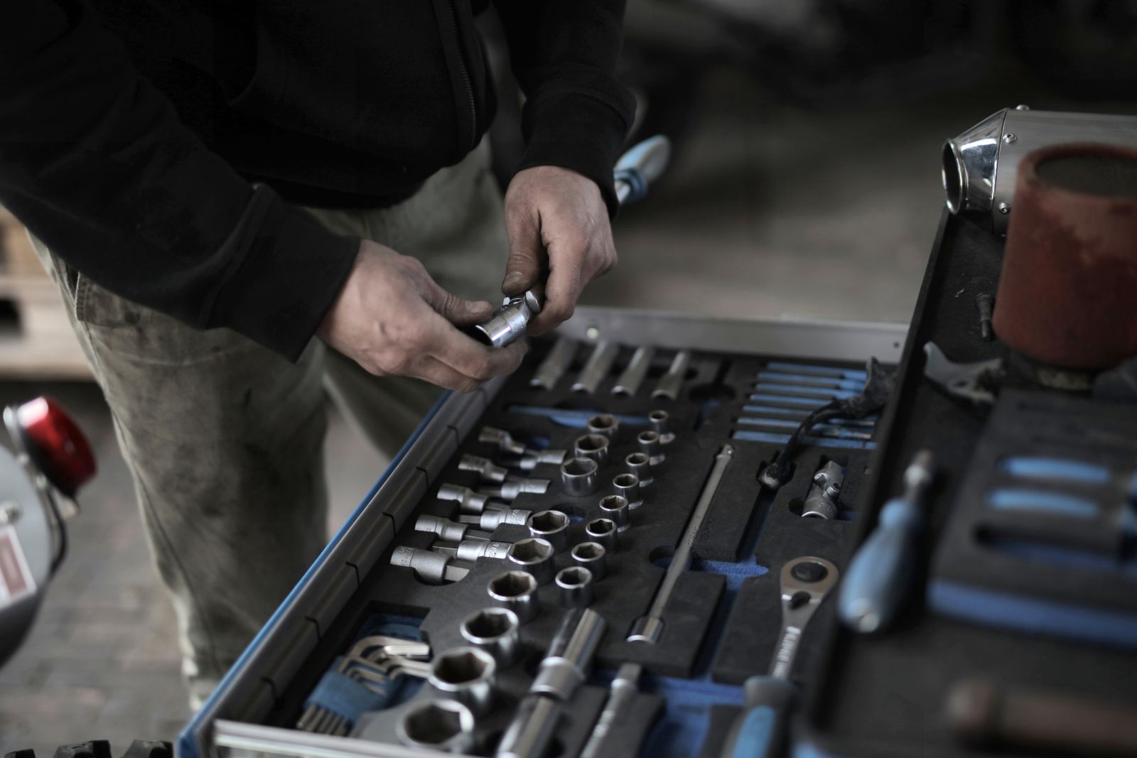 Mechanic selecting a socket from an organized tool drawer